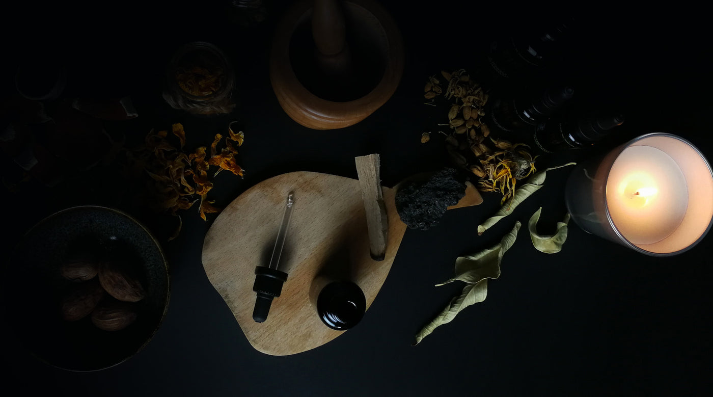a skincare product on a wooden cutting board next to leaves and a candle